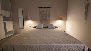 Postel nebo postele na pokoji v ubytování RoRà 1962 - Boho Chic Rooms Torre Lapillo