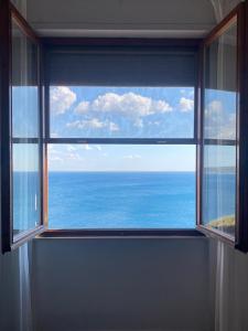 a window in a room with a view of the ocean at Il Romito in Quercianella