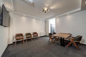 a conference room with a wooden table and chairs at Forty One Suites Belgrade Apartments in Voždivac