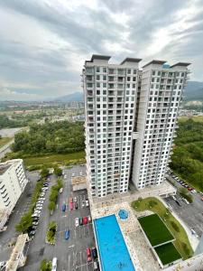 an aerial view of two tall buildings with a parking lot at Allure - Casa Kayangan Meru Ipoh by GOSWELL in Ipoh