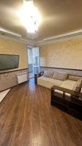 a large room with two beds and a flat screen tv at VIP апартаменти ЦЕНТР in Rivne