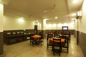 een restaurant met tafels en stoelen in een kamer bij Airport Hotel Classic Park in New Delhi