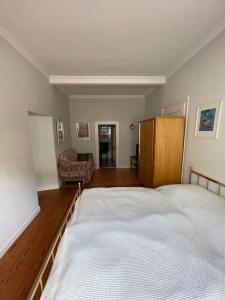 a bedroom with a large bed and a chair at Ferienwohnung Moselsteig in Reil