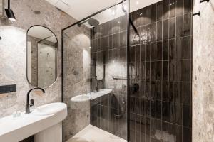 a bathroom with a shower and two sinks and a mirror at Residenza Leutari in Rome +63 photos