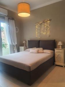 a bedroom with a large bed and a window at La Roja Grand apartement luxury 3 bedrooms in Ventimiglia