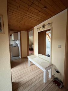 a white bench in a room with a window at Ferienwohnung Hänel in Antonshöhe +18 photos