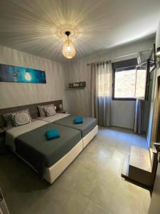 a bedroom with a large bed with blue pillows at Stavros luxury apartment in Skiathos Town +29 photos