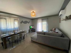 a living room with a couch and a table at Stavros luxury apartment in Skiathos