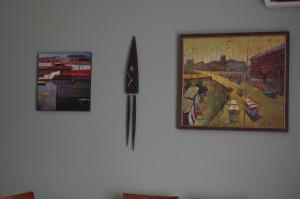 a clock and a painting on a wall at Art Cascade in Yerevan