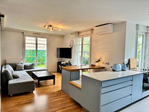 a kitchen and living room with a couch and a table at The Green Terrace Disneyland in Chessy