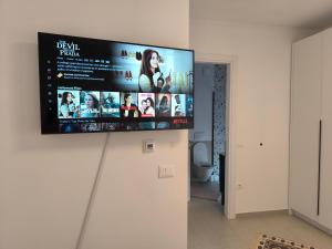 a flat screen tv on a wall in a room at Serenade Apartment in Korçë
