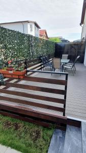 una terrazza in legno con sedie e recinzione di MRȘ House 1 a Bucarest