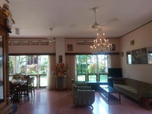 a living room with a couch and a chandelier at Srilal's Guest House in Negombo