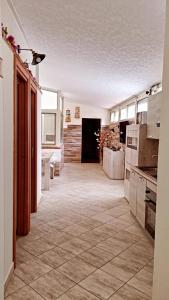 a large kitchen with a tile floor in a room at Trinacria in Catania