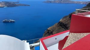 a cruise ship in the ocean on a cliff at Hara's houses in Imerovigli +105 photos