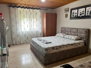 a bedroom with a large bed and a window at Vatra Traditional Guesthouse in Lekdush