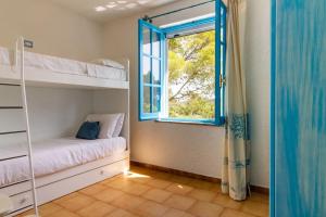 En eller flere senge i et værelse på Villa Mario & Anna Carloforte