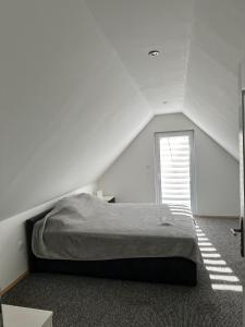 a white room with a bed and a window at Villa Akish in Bijeljina