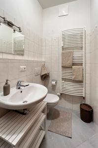 a white bathroom with a sink and a toilet at Alpine Pearl in Mallnitz