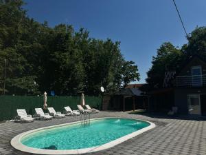 a small swimming pool with chairs and a table at Villa Akish in Bijeljina +44 photos