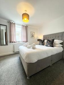a bedroom with a large bed and a large window at The Town House inn, Ulverston - Lake District in Ulverston