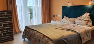 a bedroom with a large bed with a large window at Taunusblick in Bad Camberg