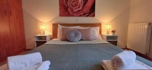 a bedroom with a large bed with two chairs at Verdalia Private Holiday House in Stavrákia
