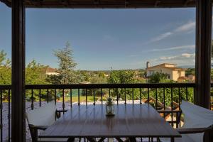 a table and chairs on a balcony with a view at ZeusPlace Traditional Villa Peponi in Katerini