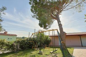 a swing set in front of a tree at ZeusPlace Traditional Villa Peponi in Katerini