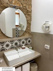 a bathroom with a sink and a mirror at Tenute Plaia Agriturismo in Scopello