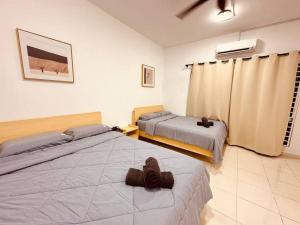 a bedroom with two beds in a room at Kuala Selangor 16pax, Karaoke ,End lot 3 Storey in Bukit Rotan