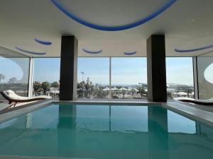 a swimming pool with a view of a building at Edison Hotel Seaview & SPA in Sottomarina