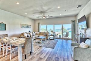 a living room with a table and a couch at Madeira Del Mar Penthouse #2- Premier in St. Pete Beach