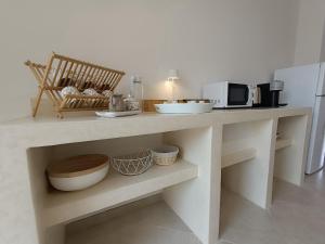 a kitchen with a counter with a microwave at LA PERLA, comfort e relax in Vignacastrisi +140 photos