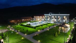 a large building with a courtyard at night at In Gremi Hotel in Gremi