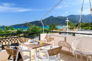 a balcony with a table and chairs and a view of the ocean at Fotini Studios in Chrysi Ammoudia