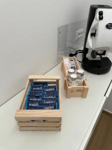 two wooden boxes on a counter next to a coffee maker at B&B Profumo di mare in Capaccio-Paestum