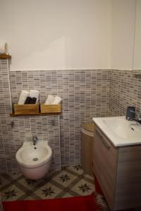a bathroom with a sink and a toilet at B&b A casa di Lò CIN F3325 in Baunei +19 photos