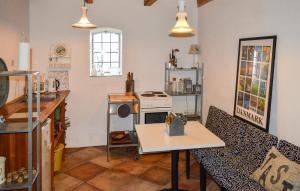 a kitchen with a stove and a table in it at Stalden in Mariager