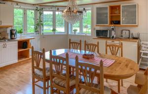 a kitchen and dining room with a wooden table and chairs at Cozy Home In Tranås With Kitchen in Tranås