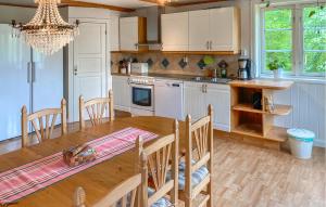 a kitchen with a wooden table and a dining room at Cozy Home In Tranås With Kitchen in Tranås