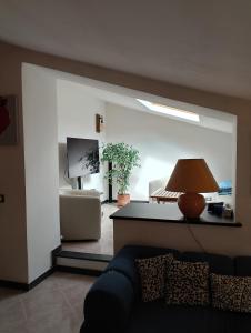 ein Wohnzimmer mit einem Sofa und einem Tisch mit einer Lampe in der Unterkunft La medievale 1 in Pignone