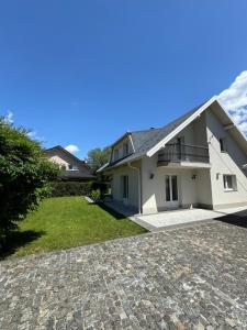 a house with a stone driveway in front of it at Villa Osik in Sarajevo