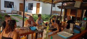 a group of people sitting at a table at CASA MIA INN in Dauis