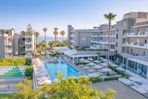 an aerial view of a resort with a pool and chairs at Kos Divine Hotel & Suites in Kos