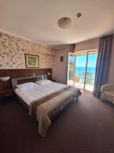 a bedroom with a large bed and a large window at VILLA VOLOSKO with private parking and breakfast,seaview in Volosko