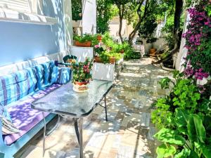 a table with a vase of flowers on a patio at House with garden in city of Rhodes in Rhodes Town