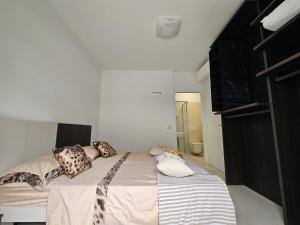 a bedroom with a bed with pillows on it at Grey House 5 100mt dal mare in Tortoreto Lido
