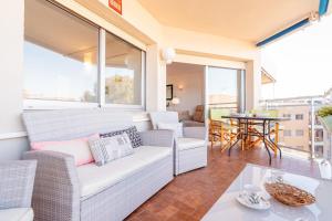 a living room with a couch and a table at Inspira by Unik Vacation in Torredembarra