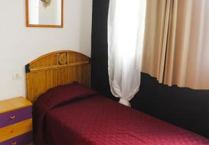A bed or beds in a room at Alcaravaneras Hostel